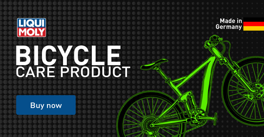 Advertisement for Liqui Moly bicycle care product with a green bicycle illustration on a dark background.